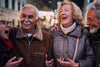 older group of friends laughing and having a good time outside during the winter